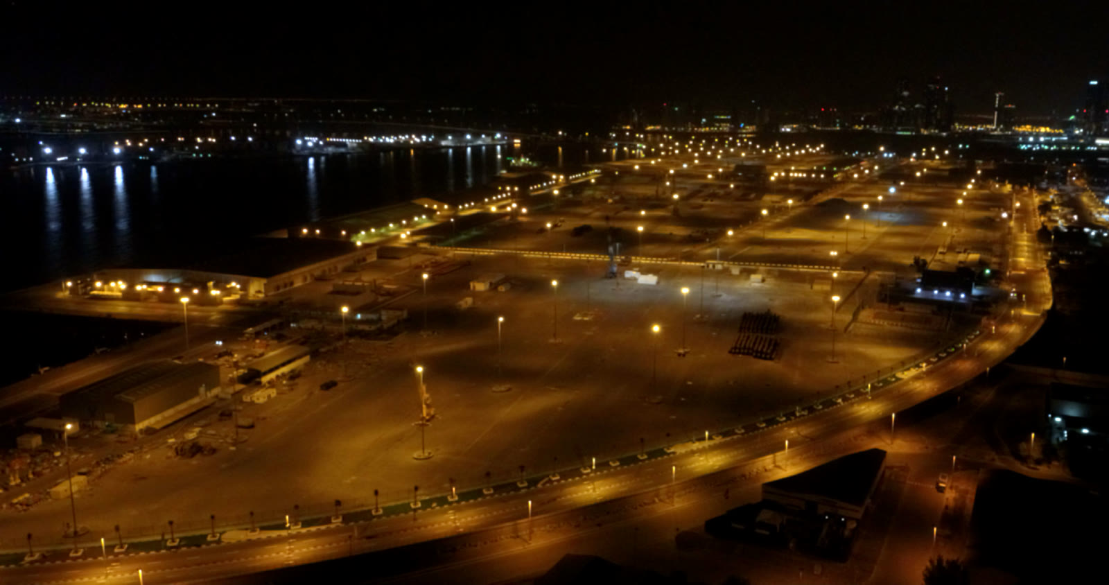 Mina Zayed Port before — dim amber sodium lighting across the terminal yard