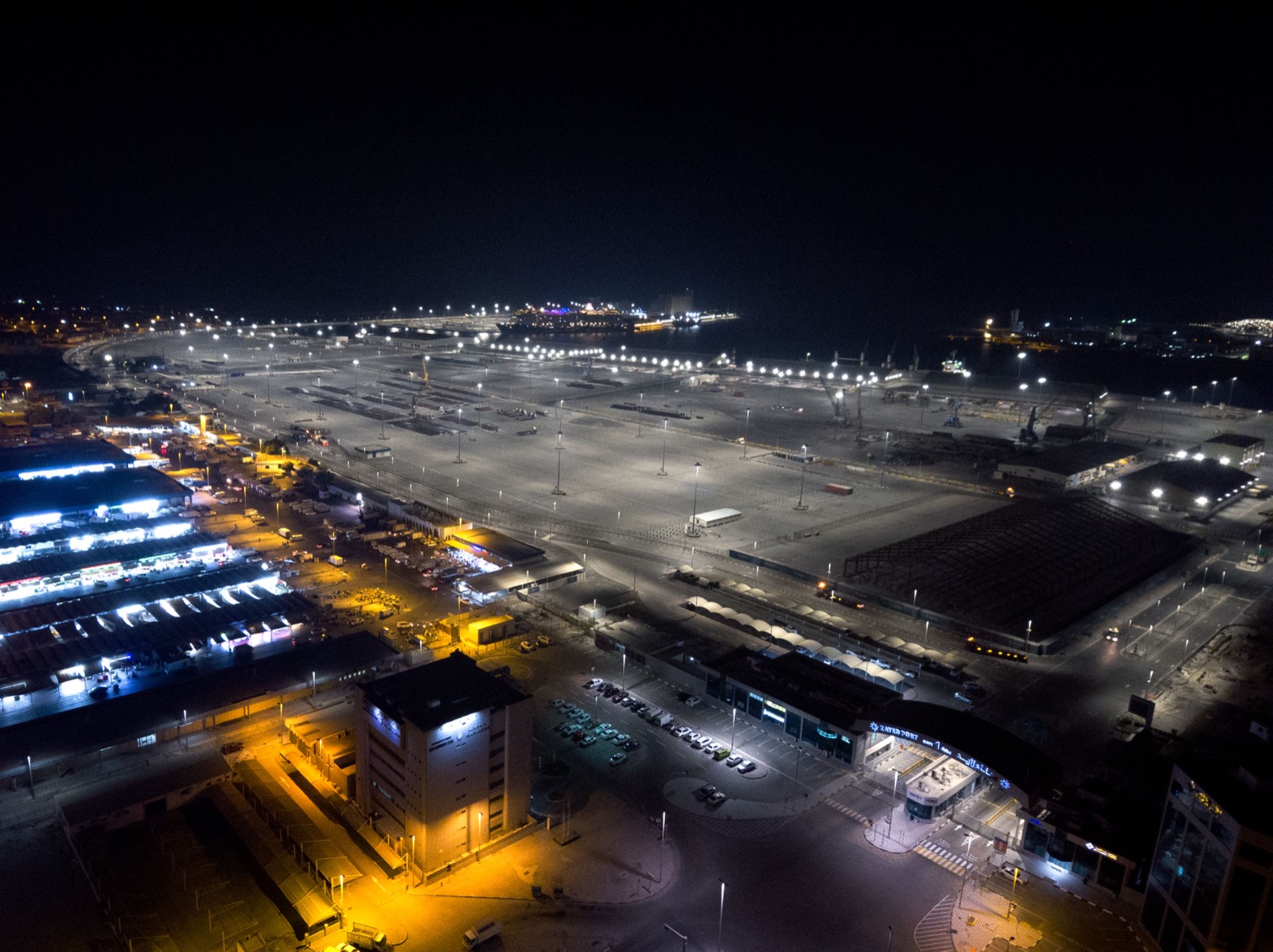 Zayed Port cargo yards after R9 conversion — uniform white light across the port