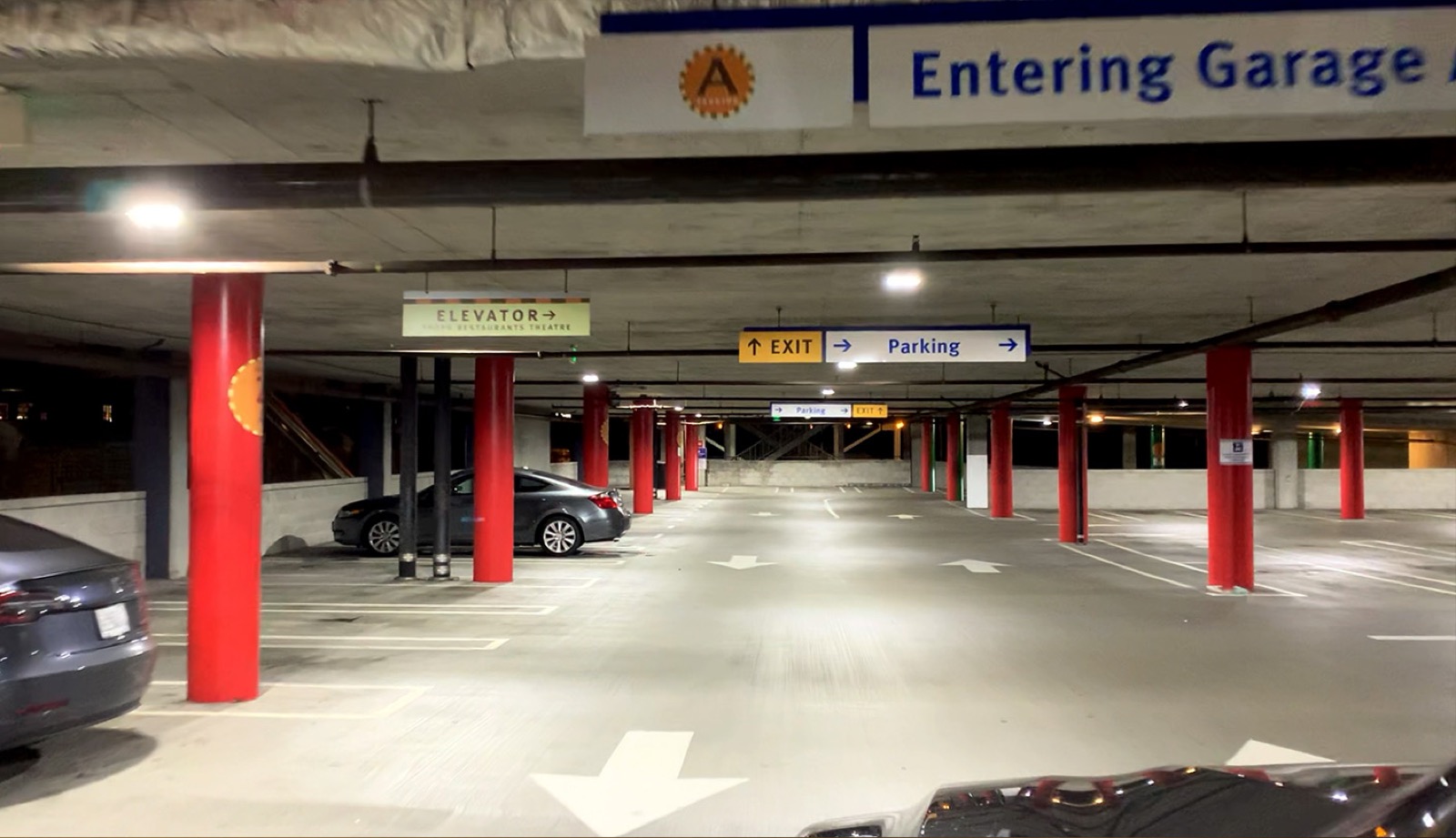 The same garage aisle after R9 upgrade — bright, even white light