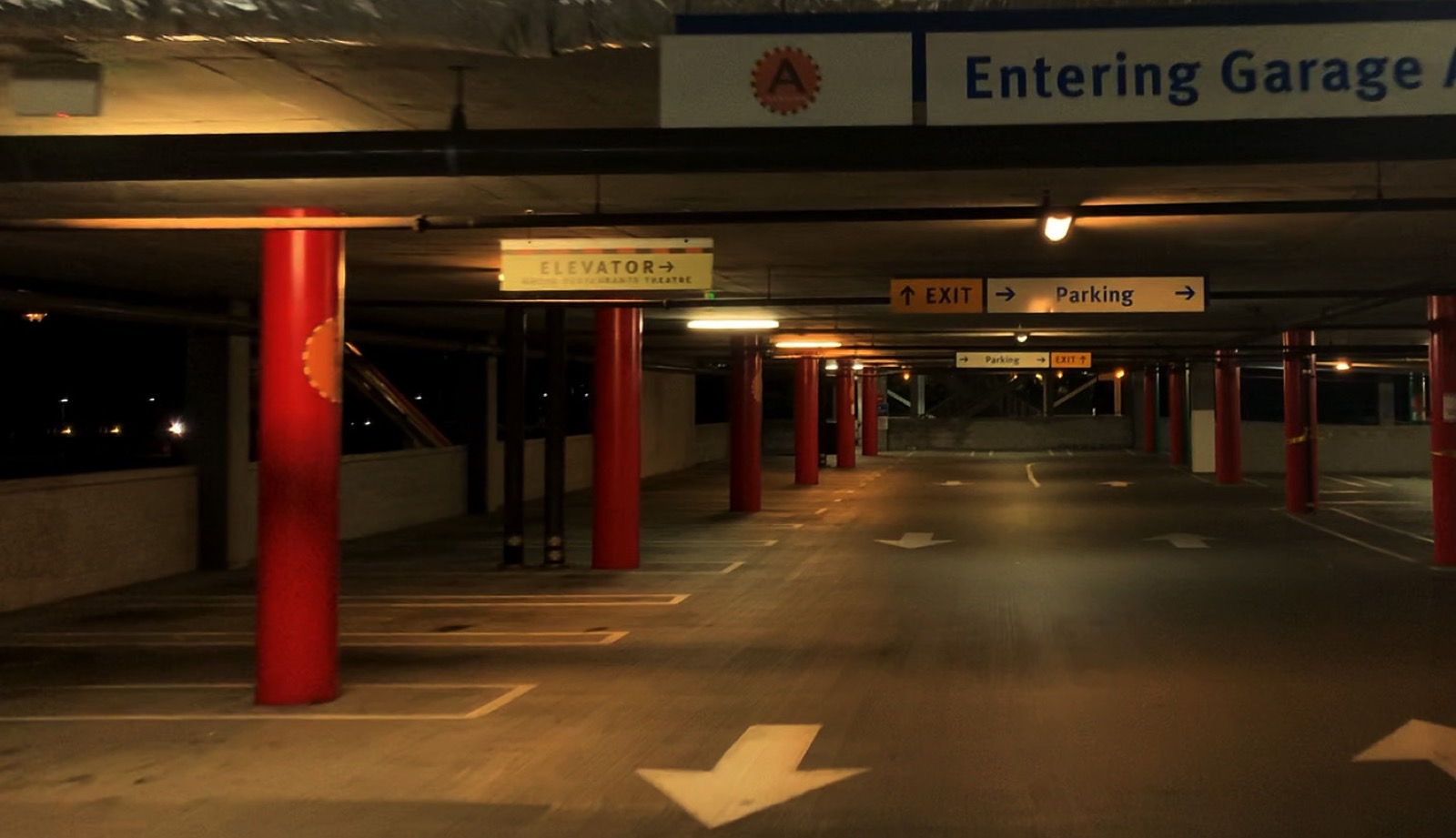 Parking garage before upgrade — dim, uneven amber lighting