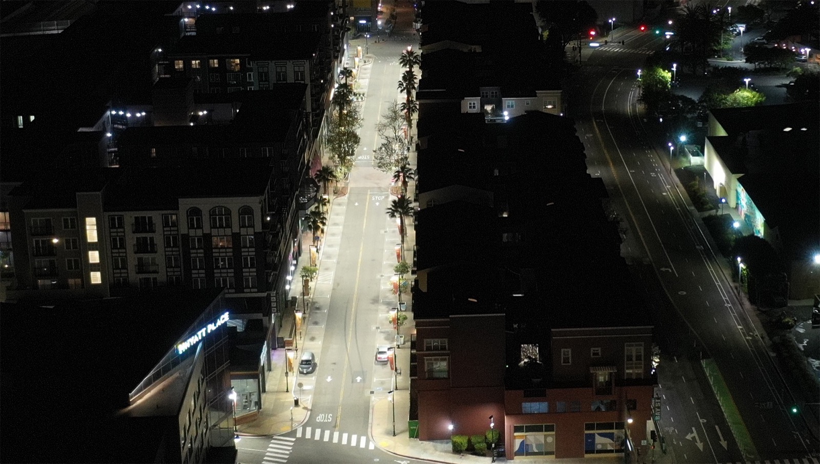 The same street after R9 upgrade — roadway and sidewalks evenly lit end to end