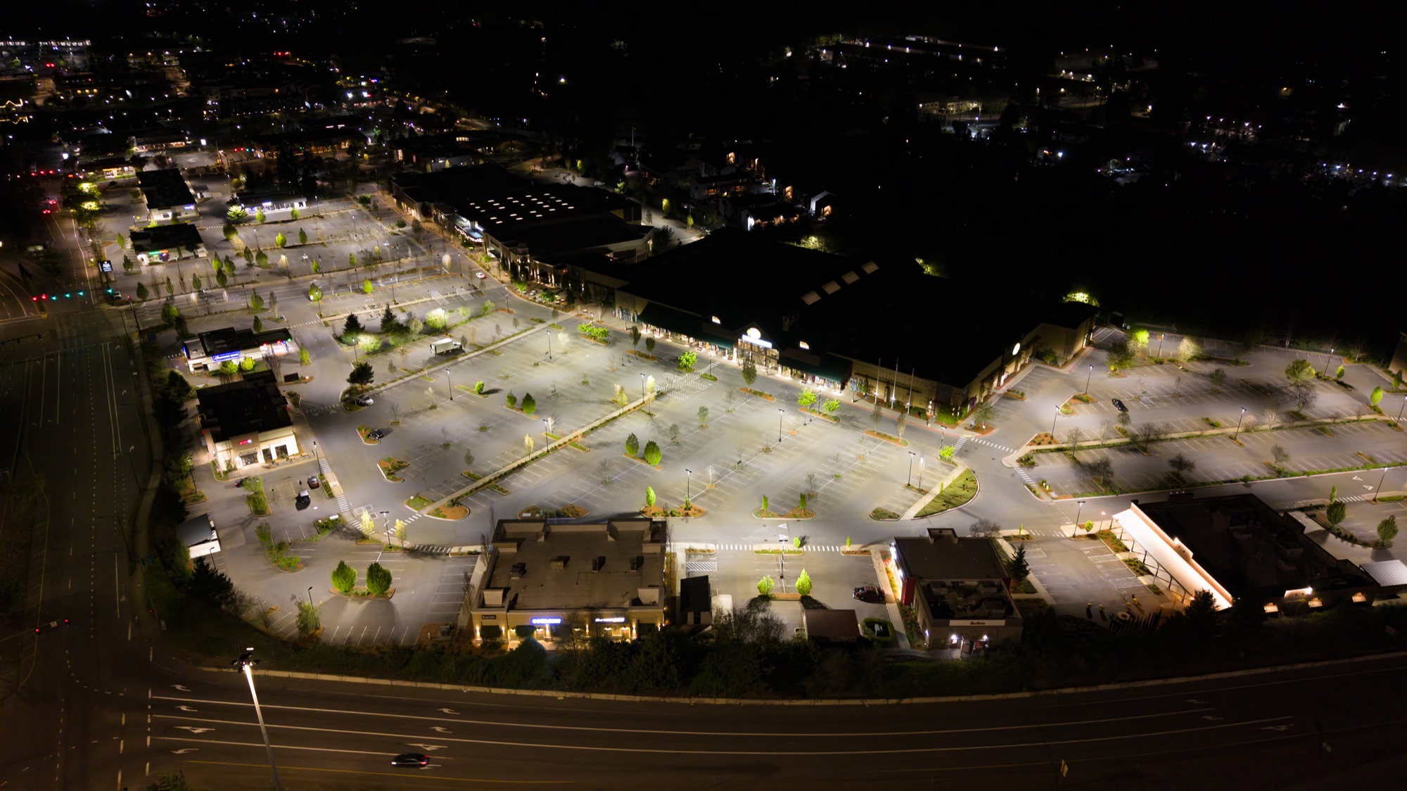 Aerial of Nyberg Rivers at night — uniform R9 parking lot lighting across the entire site