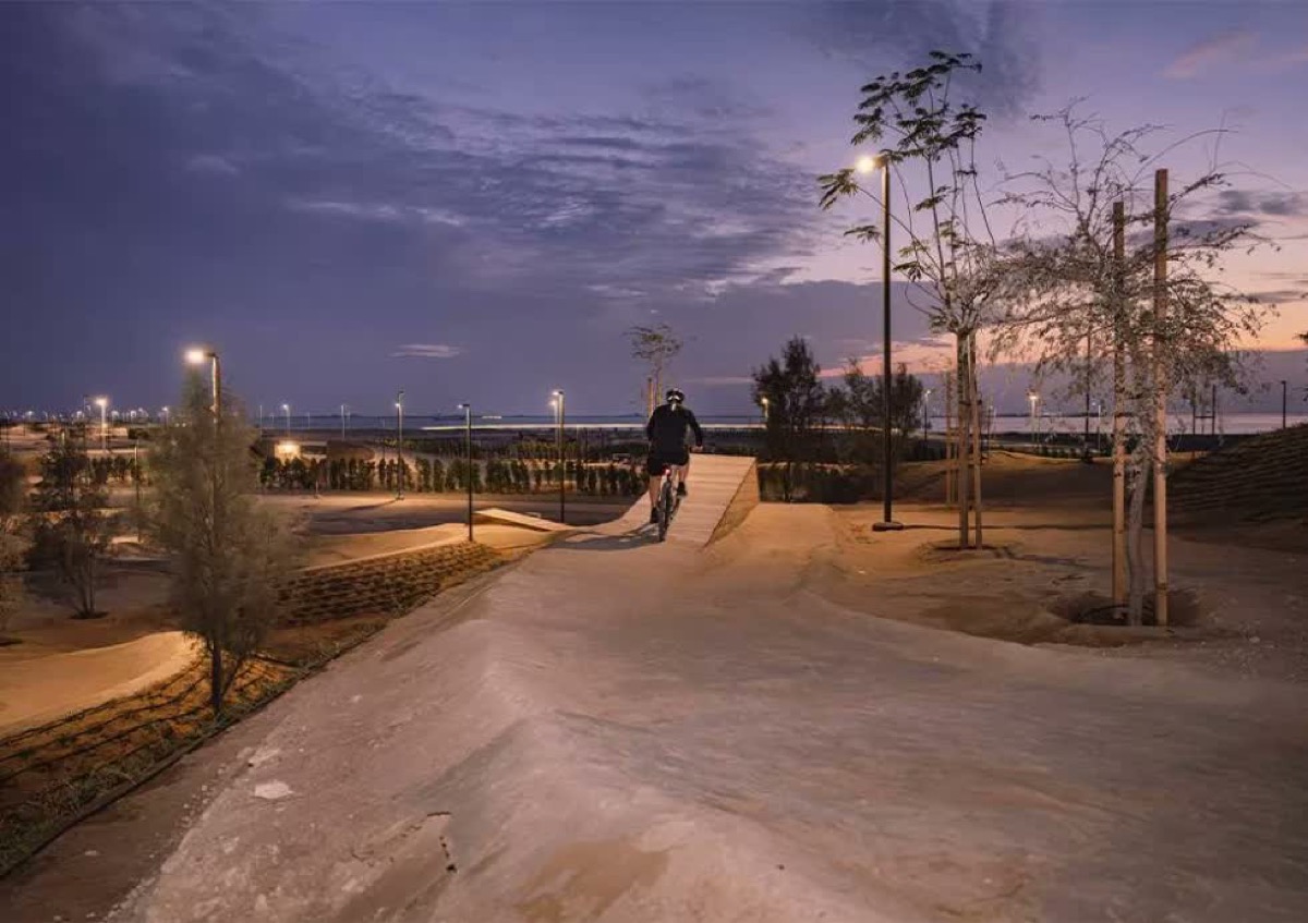 Trail X at dusk — R9 lighting illuminating the trails and ramps